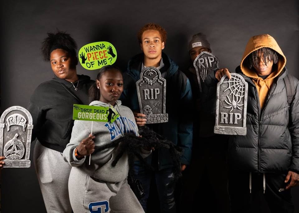 Students posing with photobooth props
